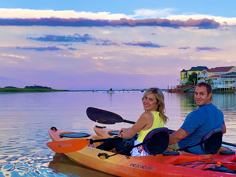 Couple kayaking in north myrtle beach at sunset with J & L Kayak Tours